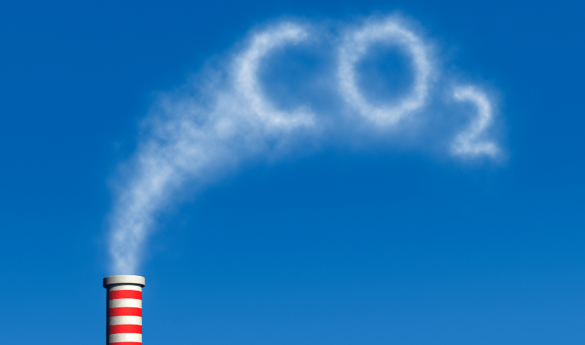 A factory smokestack emitting a cloud shaped as 'CO₂,' symbolizing carbon dioxide emissions and environmental impact.