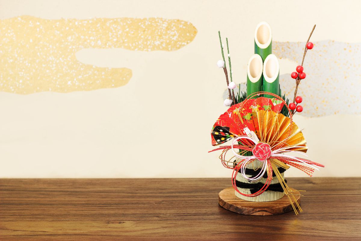 A traditional Japanese New Year’s decoration, featuring a bamboo kadomatsu with vibrant red and gold accents, symbolizing prosperity and good fortune for the coming year.