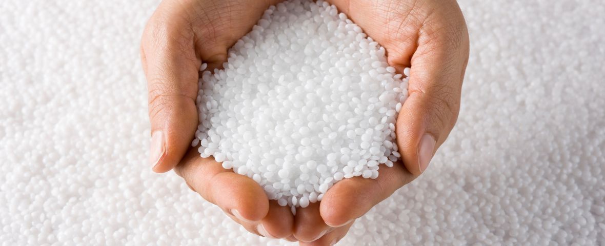 An image symbolizing the company profile page of CTE, featuring plastic pellets held in hands