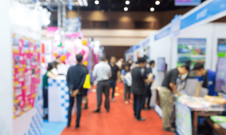 CTE participating in a trade show event in Osaka, with a bustling atmosphere of visitors exploring colorful booths and engaging with exhibitors