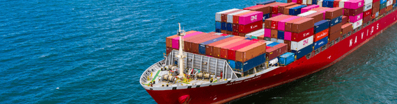 Image representing CTE's global import and sales network, featuring a large cargo ship transporting containers across the ocean