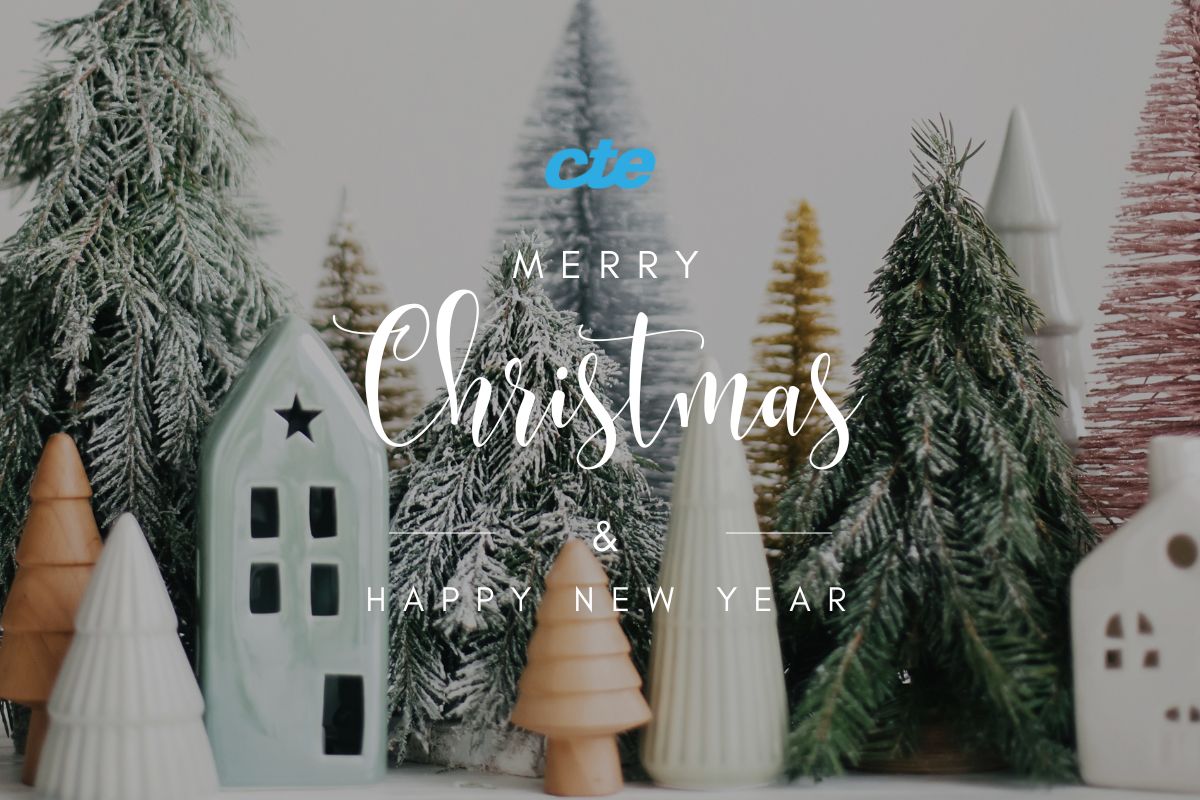 CTE holiday greeting image featuring winter trees and miniature houses, celebrating Christmas and the New Year