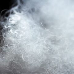 Close-up of shredded plastic fiber scrap with extremely low bulk density, illustrating air-rich nylon fibers used in recycling and extrusion processing.